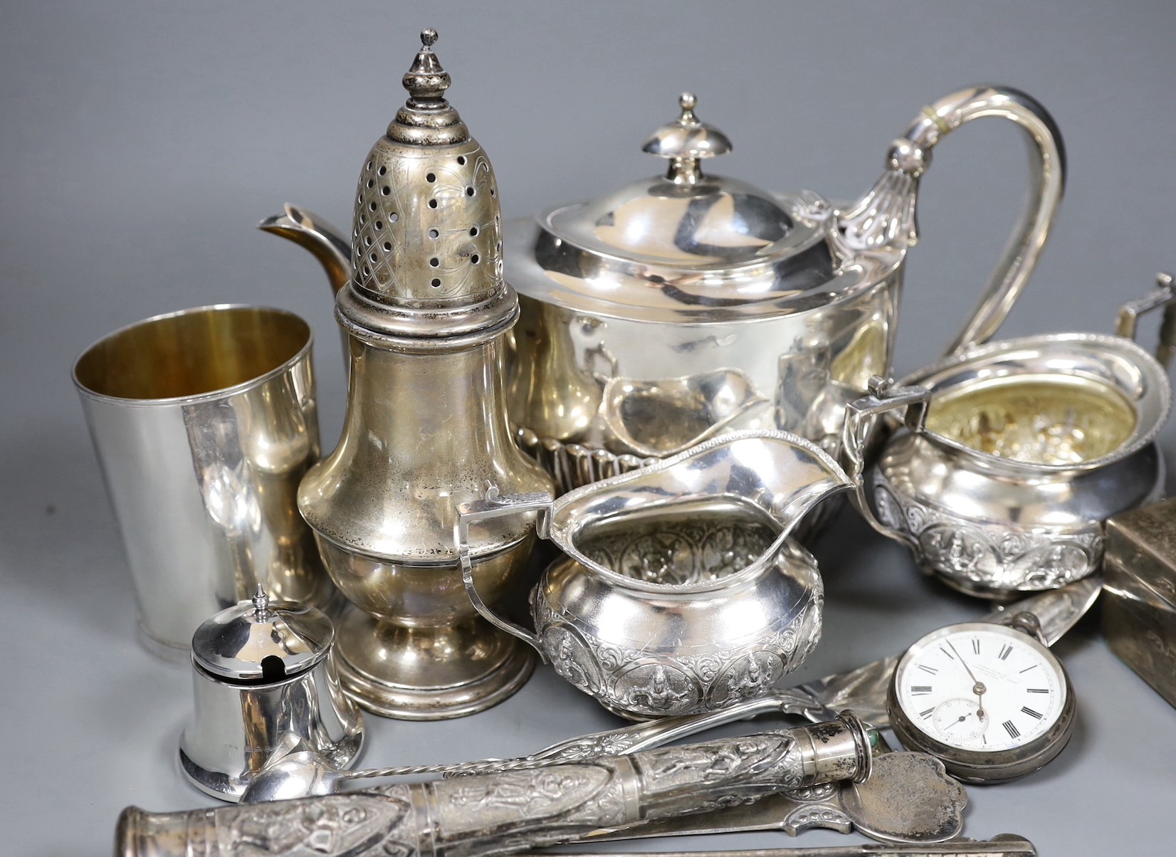 An Indian white metal cream and sugar bowl by Krishnian Chetty of Bangalore, a modern silver beaker by The Marlow Brothers, a sterling sugar caster, silver cigarette box, Chinese white metal teapot and nine other items.